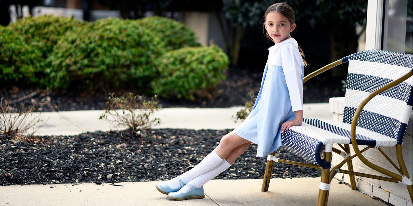 A single image of a young girl wearing a Footmates "Allie" Mary Jane shoe in the "2234" Blue Pearl color.  There is a clickable link in the bottom left corner of the image to "Shop Footmates Allie Mary Jane Shoes".
